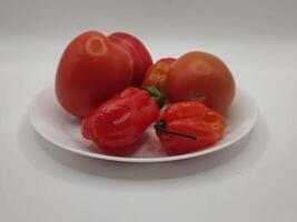 Tomato onion and scotch bonnet pepper in plate photo
