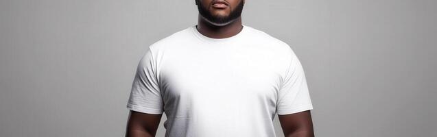 Confident man in white t-shirt posing against a gray background photo