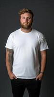Young man poses confidently in plain white t-shirt against dark background photo