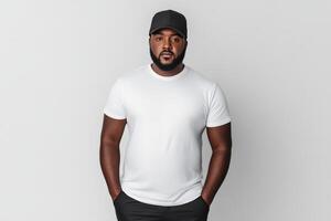 Man confidently posing in a white shirt and cap on a neutral backdrop photo