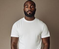 Confident man poses in a simple white shirt against a neutral background photo