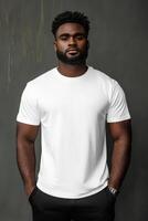 Confident young man poses in plain white t-shirt against a minimalist backdrop photo