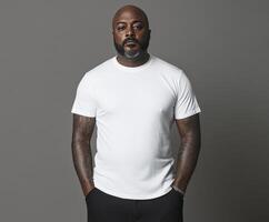Confident individual poses in casual attire against a gray backdrop photo