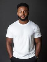 Confident young man posing in a bright white shirt against a dark background photo