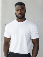 Man in white shirt poses confidently against a simple background photo