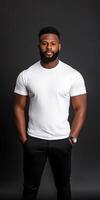 Man in white t-shirt poses confidently against a dark backdrop photo