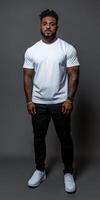 Strong man poses confidently in neutral background with casual attire photo