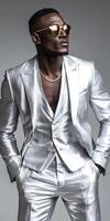 Stylish man in a shining silver suit striking a confident pose indoors photo