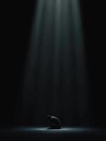 Dramatic lighting highlights a solitary figure in a dark environment photo