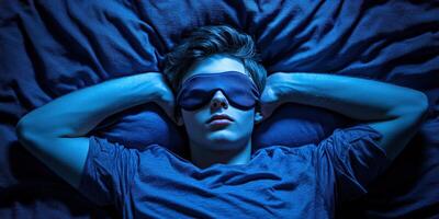 Young person sleeping peacefully with an eye mask in a dim room photo