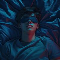 Teen resting peacefully in a dimly lit bedroom with sleep mask on photo