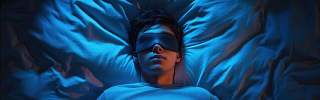 Teenager resting with sleep mask in dimly lit bedroom at night photo