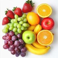 Vibrant assortment of fresh fruits arranged on a white background photo