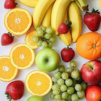 Fresh assortment of colorful fruits arranged on a white background photo