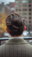 Stylish man with elegant hairstyle observed from behind in urban setting photo