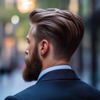 Man with stylish haircut and beard walks in urban setting during daytime photo