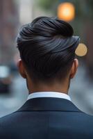Stylish haircut showcases modern grooming in urban setting photo
