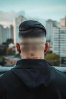 Stylish haircut on a young man with city skyline backdrop during twilight photo