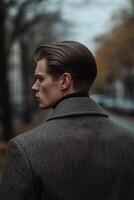 Stylish man walks through an autumn street with a sophisticated coat photo