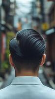 Modern hairstyle of a man in a narrow urban alley during daylight photo