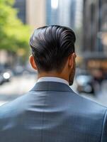Stylish man in suit walking through a busy city street during the day photo
