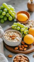 Healthy breakfast with oatmeal, almonds, and fresh fruits on a wooden table photo