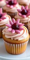Delicious cupcakes decorated with pink flowers and berry topping photo