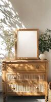 Wooden dresser adorned with plants and a blank frame in soft light photo