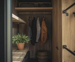 Cozy entryway with organized coats and a decorative plant in a wooden closet photo