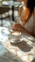 Warm coffee and morning light at a cozy cafe table in summer photo