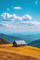 Beautiful wooden house on a hilltop with mountains in the background photo