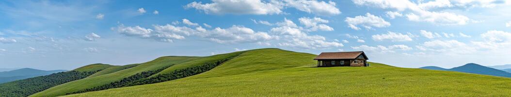 Serene hillside with a rustic cabin under a clear blue sky photo
