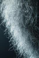 Close-up view of white wool fibers showcasing texture and detail photo