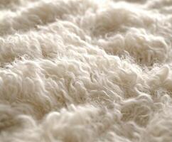 Soft and fluffy wool texture displayed on a gentle surface photo