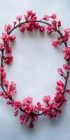 Cherry blossom wreath made of delicate pink flowers on a light background photo