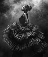 Elegant dancer in dramatic black attire against a smoky background photo