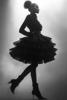 Elegant fashion model poses in dramatic silhouette against soft background photo