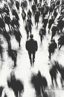 Man standing still among a blur of moving crowds in a busy urban setting photo