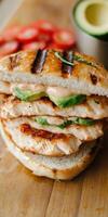 Grilled chicken sandwich with fresh vegetables and avocado photo