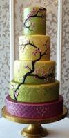 Elegant multi-tiered cake featuring floral designs and vibrant colors photo