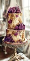 Elegant two-tier cake decorated with purple roses and hearts in a bright room photo