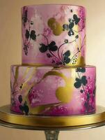 Elegant two-tier cake with floral design and gold accents for special occasions photo