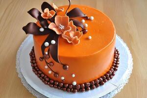 Celebrate with a vibrant orange cake adorned with beautiful flowers and ribbons photo