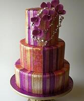 Elegant three-tier cake adorned with purple orchids and pearls for celebrations photo
