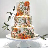Exquisite three-tier cake adorned with floral designs and vibrant colors photo