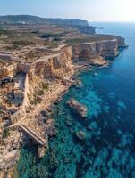 Scenic coastal view of rocky cliffs and blue waters near coastline photo