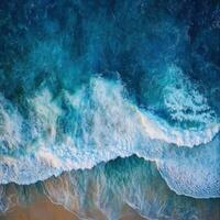 Beautiful ocean waves crashing on sandy beach during sunny day photo