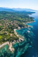 Scenic coastal view of lush greenery and crystal clear waters in summer photo