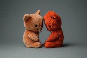 Two plush toys embracing with a gentle connection on a gray backdrop photo