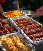 Grilled assorted meats and sides served at a summer barbecue gathering photo